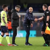 Enzo Maresca, Manager of Chelsea, shakes hands with Assistant Referee Scott Ledger as Ivan Juric, Manager of Southampton, looks on during the Premier League match between Chelsea FC and Southampton FC at Stamford Bridge on February 25, 2025 in London, England. 