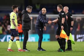Enzo Maresca, Manager of Chelsea, shakes hands with Assistant Referee Scott Ledger as Ivan Juric, Manager of Southampton, looks on during the Premier League match between Chelsea FC and Southampton FC at Stamford Bridge on February 25, 2025 in London, England. 