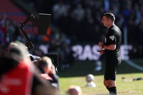 Match Referee Michael Oliver reviews an incident on the pitch side VAR monitor which resulted in a red card decision during the Emirates FA Cup Fifth Round match between Crystal Palace and Millwall at Selhurst Park on March 01, 2025 in London, England. 
