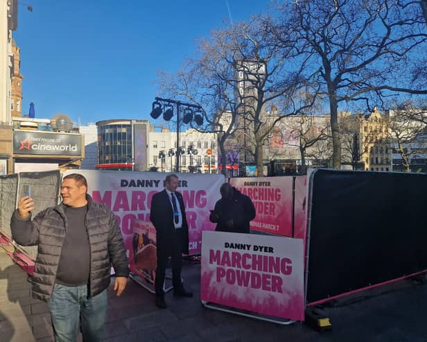 Fans pose for photos outside Cineworld as set up continues 