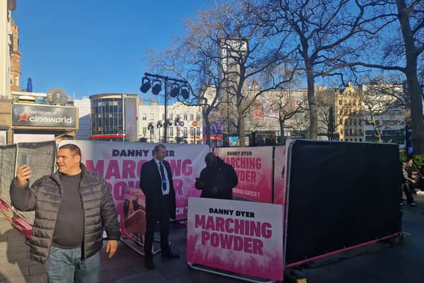 Fans pose for photos outside Cineworld as set up continues 