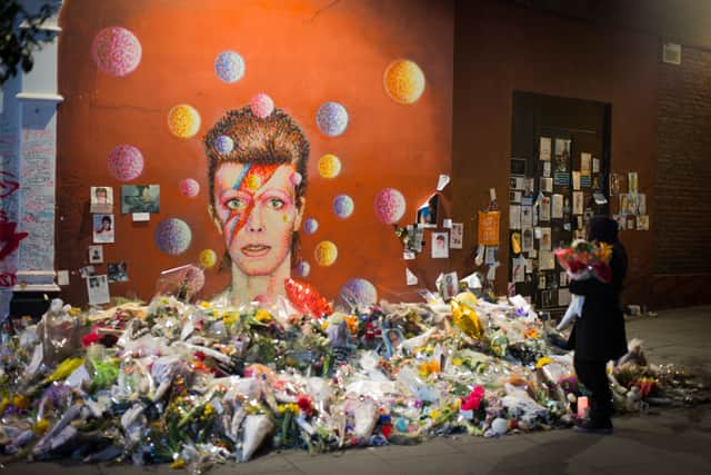Flowers laid at a David Bowie Ziggy Stardust mural in Brixton after his death in 2016