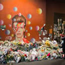 Flowers laid at a David Bowie Ziggy Stardust mural in Brixton after his death in 2016