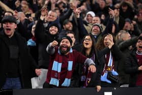 West Ham supporters gesture towards the Wolverhampton Wanderers supporters during the Premier League match between West Ham United FC and Wolverhampton Wanderers FC at London Stadium on December 09, 2024 in London, England