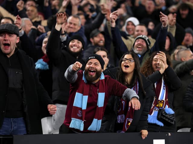 West Ham supporters gesture towards the Wolverhampton Wanderers supporters during the Premier League match between West Ham United FC and Wolverhampton Wanderers FC at London Stadium on December 09, 2024 in London, England