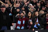 West Ham supporters gesture towards the Wolverhampton Wanderers supporters during the Premier League match between West Ham United FC and Wolverhampton Wanderers FC at London Stadium on December 09, 2024 in London, England