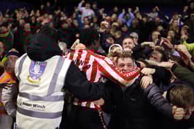 Mayenda celebrates with the fans after scoring against Sheffield Wednesday.