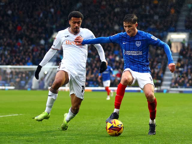 Florian Bianchini of Swansea tackles Freddie Potts of Portsmouth during the Sky Bet Championship match between Portsmouth FC and Swansea City AFC at Fratton Park on January 01, 2025 in Portsmouth, England. 