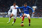 Florian Bianchini of Swansea tackles Freddie Potts of Portsmouth during the Sky Bet Championship match between Portsmouth FC and Swansea City AFC at Fratton Park on January 01, 2025 in Portsmouth, England. 