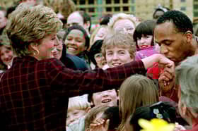 Princess Diana receives a kiss on the hand from trainee electrician Danny Walters, 29, during a walk in Southwark, South London, on 10th March 1993. 