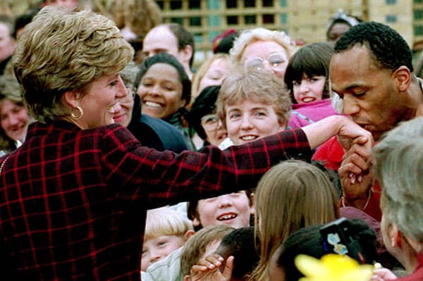 Princess Diana receives a kiss on the hand from trainee electrician Danny Walters, 29, during a walk in Southwark, South London, on 10th March 1993. 