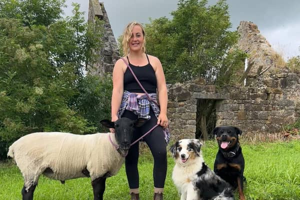 Robyn Swan moved out of her home to live rent-free in a container in rural Scotland, growing her own food and harvesting rainwater. She is pictured with her pet sheep and dogs. Photo: Robyn Swan / SWNS