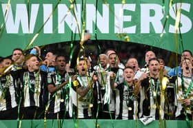 Bruno Guimaraes and Kieran Trippier of Newcastle United lift the Carabao Cup Trophy after his team's victory in the Carabao Cup Final between Liverpool and Newcastle United at Wembley Stadium on March 16, 2025 in London, England. 
