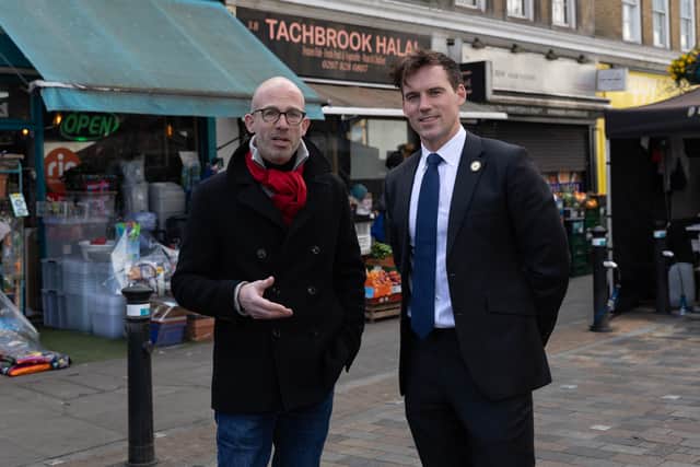 Councillors Geoff Barraclough (L) and Ed Pitt Ford standing at the site in Tachbrook Market, Pimlico, where they saved a man's life through CPR