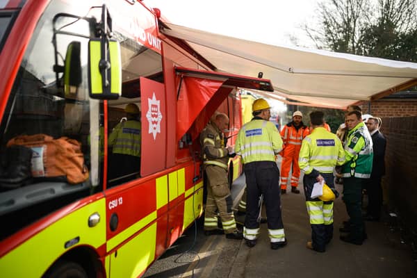 Electrical engineers gather to discuss their progress near the site of the fire at North Hyde electricity substation, at Hayes on March 21, 2025