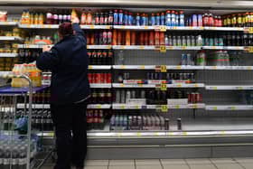 An employee stocks shelves at a Tesco supermarket in central London in 2021 (Photo: JUSTIN TALLIS/AFP via Getty Images)