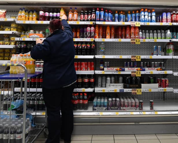 An employee stocks shelves at a Tesco supermarket in central London in 2021 (Photo: JUSTIN TALLIS/AFP via Getty Images)