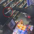 Balaclava-clad teen threatens shop owner at knifepoint.
