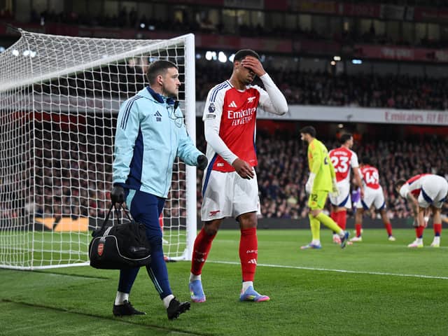 Gabriel of Arsenal looks dejected as he leaves the pitch with a member of the medical team after picking up an injury during the Premier League match between Arsenal FC and Fulham FC at Emirates Stadium on April 01, 2025 in London, England.