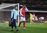 Gabriel of Arsenal looks dejected as he leaves the pitch with a member of the medical team after picking up an injury during the Premier League match between Arsenal FC and Fulham FC at Emirates Stadium on April 01, 2025 in London, England.
