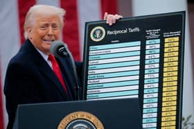 President Donald Trump holds up a chart of "reciprocal tariffs" while speaking during a trade announcement event in the Rose Garden at the White House.