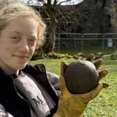 Magnet Fishing Edinburgh's Eryn and the 350-year-old cannonball found in the River Lochy in the Scottish Highlands. 
