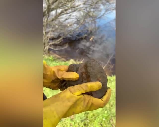 Video grab of the 350-year-old cannonball found in the River Lochy in the Scottish Highlands. 