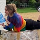 Author Charlotte Faulconbridge reading a book and smiling