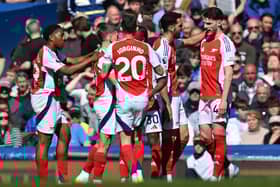 Arsenal's Belgian midfielder #19 Leandro Trossard (2L) celebrates with teammates after scoring the opening goal of the English Premier League football match between Everton and Arsenal at Goodison Park in Liverpool, north west England on April 5, 2025.