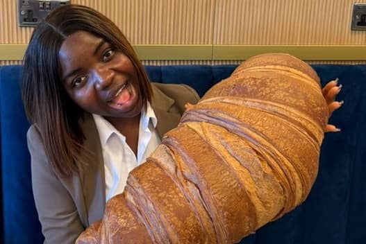 Emmanuella Okpoko with the massive croissant at P&D Gran Caffè in Liverpool.