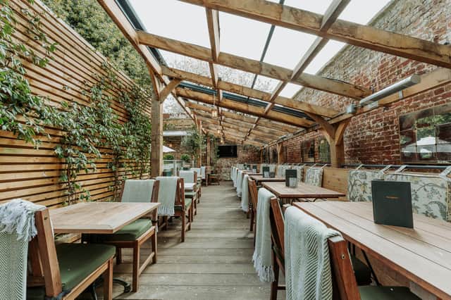How gorgeous is this semi-outdoor dining area 