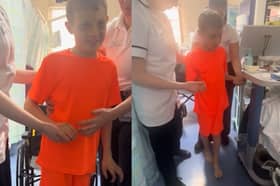Jacob, 10, takes first steps after emergency brain surgery following road traffic accident.