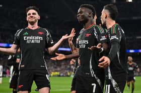 Bukayo Saka celebrates scoring Arsenal's 1st goal with Gabriel Martinelli and Declan Rice during the UEFA Champions League 2024/25 Quarter Final Second Leg match between Real Madrid C.F. and Arsenal FC at Estadio Santiago Bernabeu on April 16, 2025 in Madrid, Spain. 