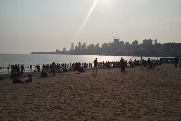 Families gather before sunset on Chowpatty beach in Mumbai