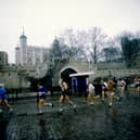 General view of competitors as they pass the Tower of London during the First London Marathon in 1981