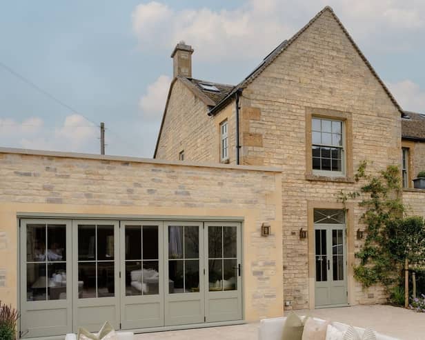 The exterior is a classic Cotswolds house, made from the local stone