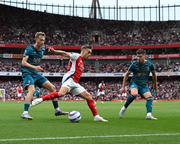 Leandro Trossard of Arsenal is challenged by Milos Kerkez and Dean Huijsen of AFC Bournemouth during the Premier League match between Arsenal FC and AFC Bournemouth at Emirates Stadium on May 03, 2025 in London, England.