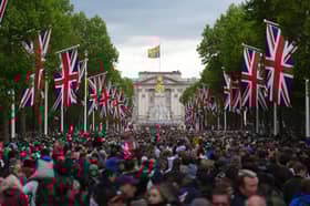 People head towards Buckingham Palace along The Mall after a military procession to mark the 80th anniversary of VE Day on May 5, 2025 in London