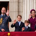 Prince William, Prince of Wales, Prince George, Prince Louis, Catherine, Princess of Wales, and Princess Charlotte on the balcony of Buckingham Palace to view the fly past