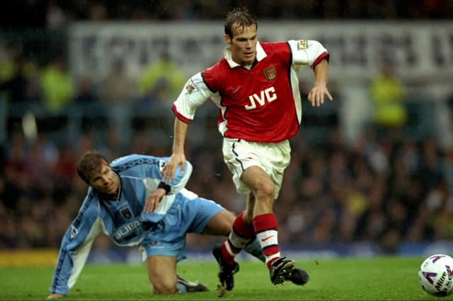 Fredrik Ljungberg of Arsenal goes past Roland Nilsson of Coventry City during the FA Carling Premiership match at Highfield Road in Coventry, England. Arsenal won 1-0. October 1998.