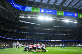 General view inside the stadium as Arsenal players warm up prior to the UEFA Champions League 2024/25 Quarter Final Second Leg match between Real Madrid C.F. and Arsenal FC at Estadio Santiago Bernabeu on April 16, 2025 in Madrid, Spain. 