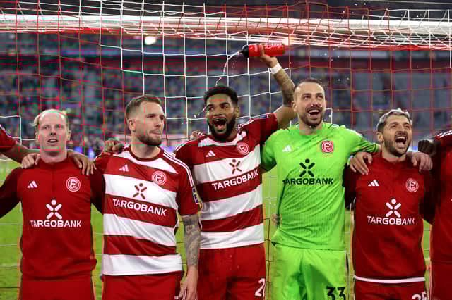 Jamil Siebert celebrates with Fortuna Duesseldorf teammates.