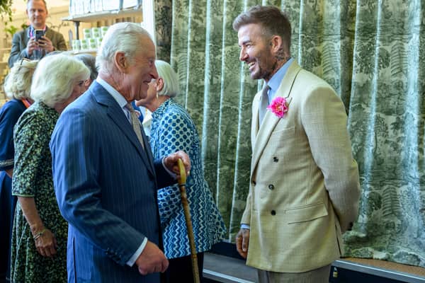 David Beckham wearing a David Austin Roses "King's Rose" speaks with King Charles III, patron of the Royal Horticultural Society during a visit to the RHS Chelsea Flower Show