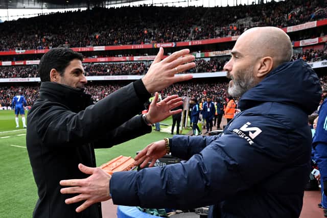 Mikel Arteta, Manager of Arsenal, and Enzo Maresca, Manager of Chelsea, embrace prior to the Premier League match between Arsenal FC and Chelsea FC at Emirates Stadium on March 16, 2025 in London, England. 