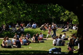 Tourists and workers enjoy the warm weather in St James' Park in London