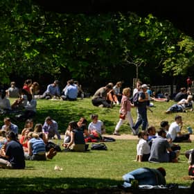 Tourists and workers enjoy the warm weather in St James' Park in London