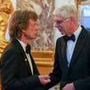 Mick Jagger shakes hands with Arsene Wenger.