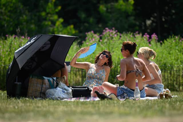 Sunbathers enjoy the heat in St James' Park on June 19, 2025