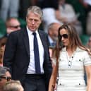 Hugh Grant and Anna Elisabet Eberstein arrive in the Royal Box at Wimbledon 