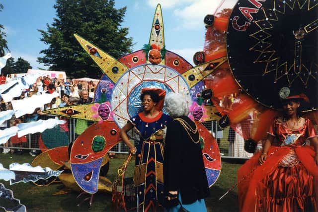Some of the colourfully dressed participants at the West Indian carnival at Potternewton Park in August 1997, talking to the Lord Mayor of Leeds, Councillor Linda Middleton.